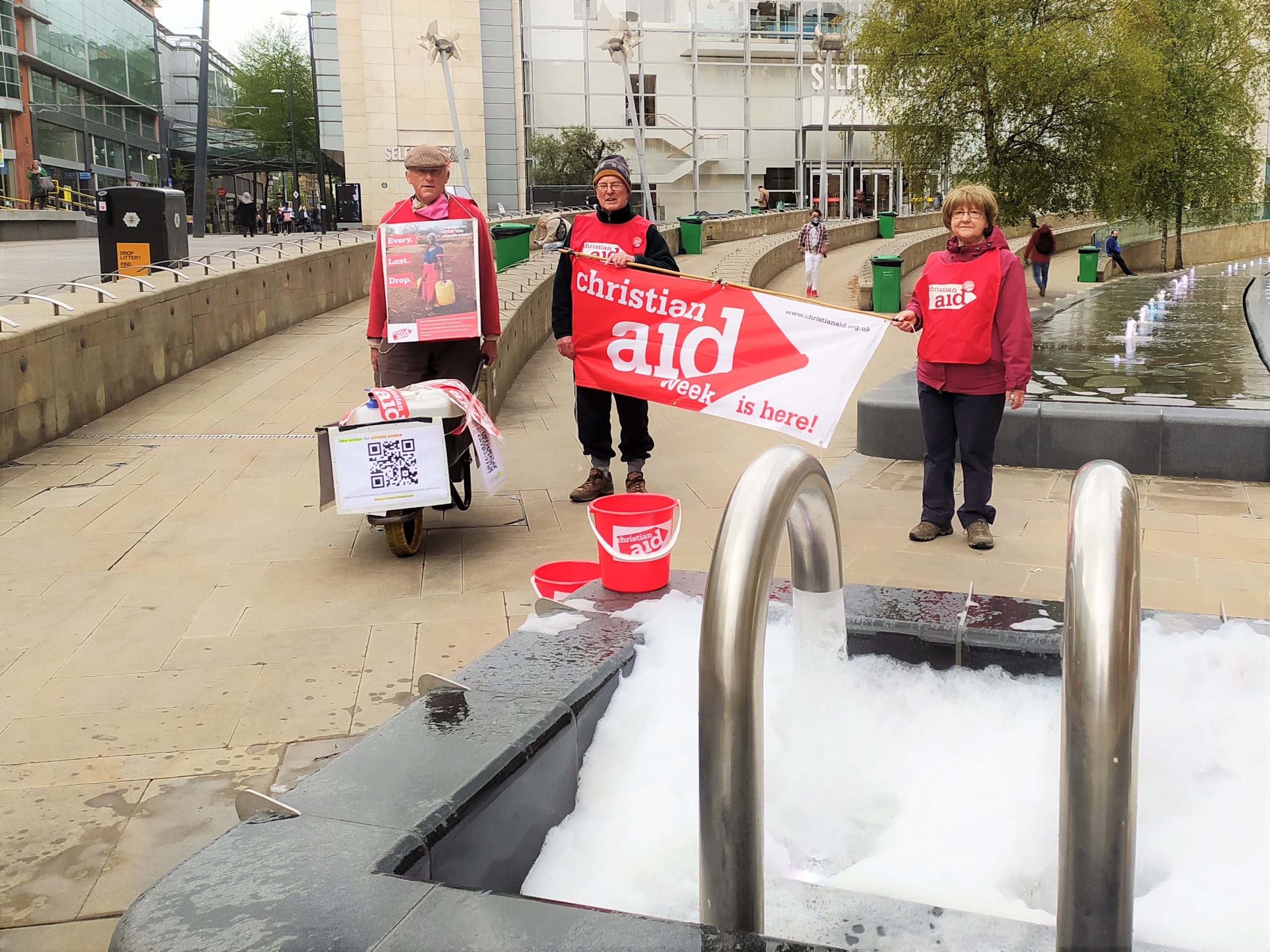 watch-christian-aid-supporters-walk-wheelbarrow-of-water-across