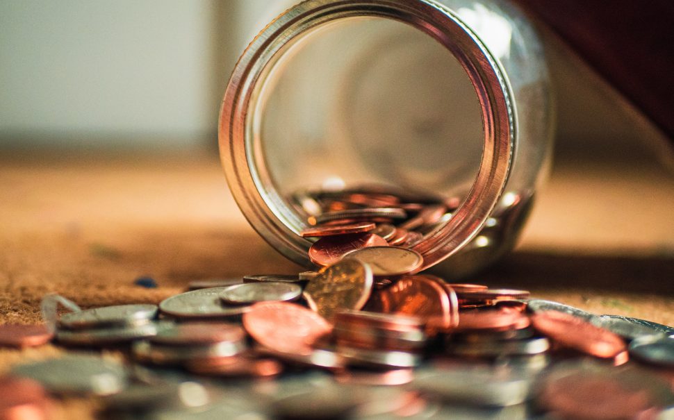 Coins spilling out of a jar