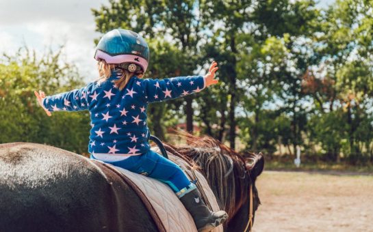 A child riding a pony