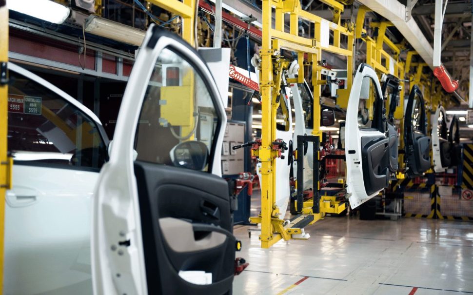 a car being constructed in an automated factory