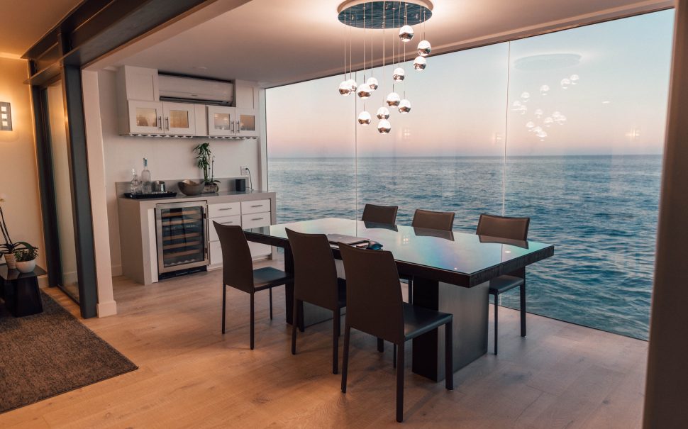 The inside of a house with a kitchen table and chairs