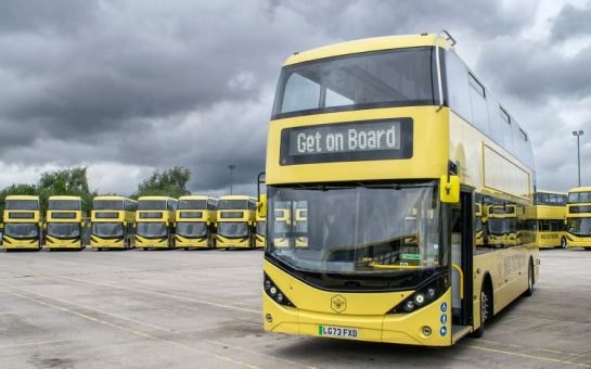 A photo of a yellow Bee Network bus. The electronic sign at the front says 'get on board'.