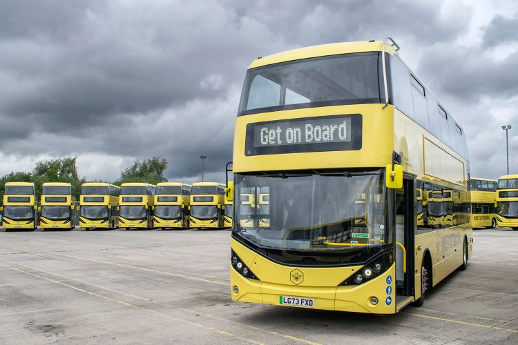 A photo of a yellow Bee Network bus. The electronic sign at the front says 'get on board'.