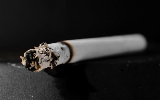 a lit cigarette in an ashtray