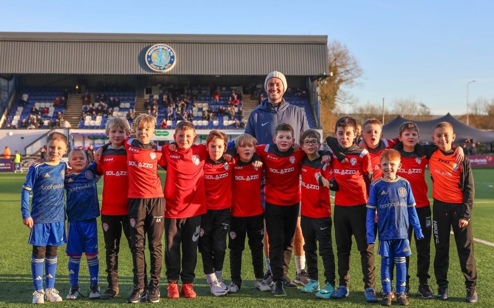 Lee Folkard (back centre) with beneficiaries of Macclesfield F.C.'s youth outreach programmes