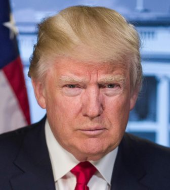 Donald Trump in the foreground, wearing a dark suit and red tie, behind him the American flag and part of the White House is visible. backgroun