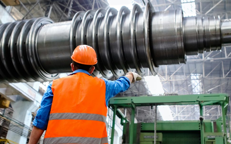 Man in hi-viz and safety gear in an industrial setting