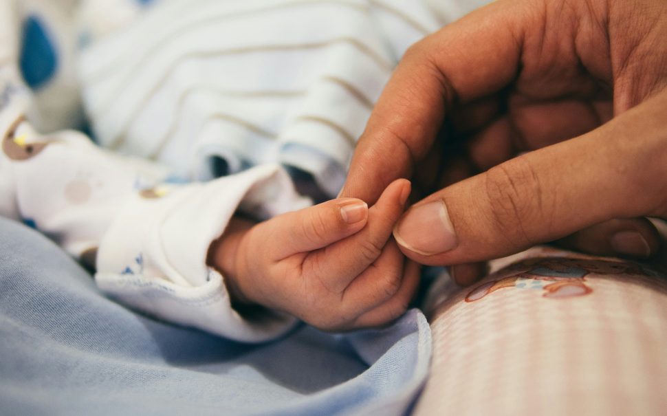 Holding baby’s hand, by Aditya Romansa on Unsplash, free to use under Creative Commons