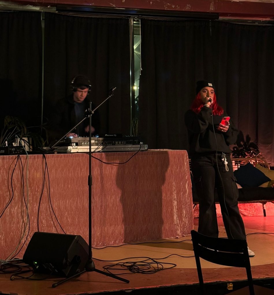 Poet/spoken word artist performing to a live music set