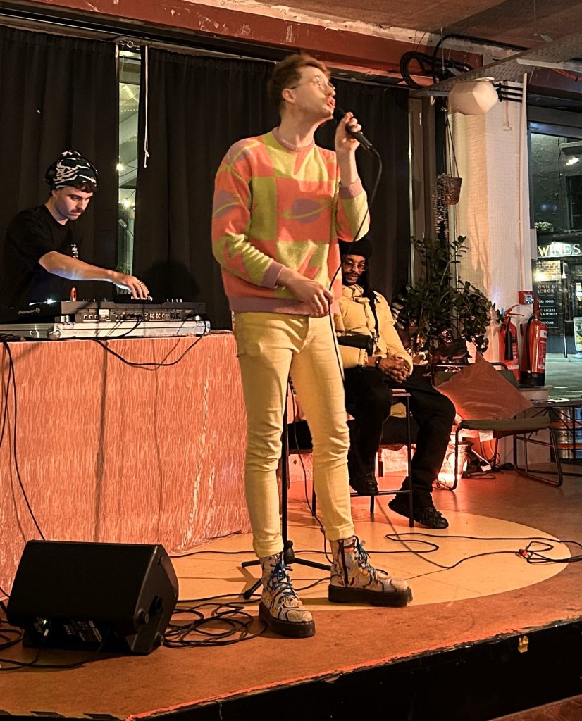 Poet/spoken word artist performing to a live music set