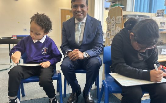 Man and two children sitting in school.